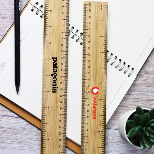 Wooden rulers, notebook, and pen on desk