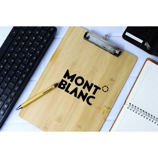 Montblanc pen on wooden clipboard with keyboard and notebook