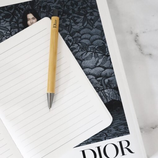 Dior pencil on notebook with artistic cover