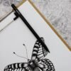 Butterfly drawing with pencil on notepad, intricate background