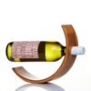 White wine bottle in curved wooden holder