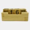 Wooden perpetual calendar showing August 16, Monday