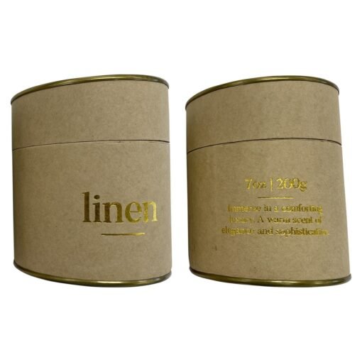 Two cardboard candle packaging with golden text 'linen'