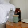 Bedside table with bottles, candle, and tea jar