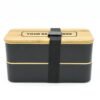 Black bento box with wooden lid and branding space
