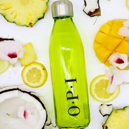 Green juice bottle with tropical fruits and flowers